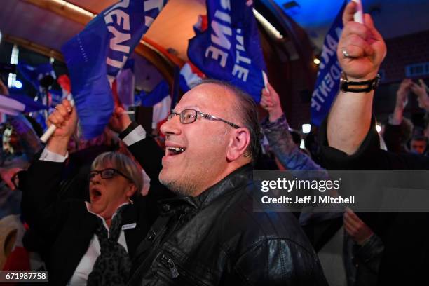 Supporters of National Front leader Marine Le Pen cheer in celebration in the Espace Francios Mitterrand on April 23, 2017 in Henin Beaumont, France....