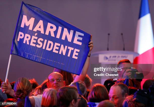 Supporters of National Front leader Marine Le Pen cheer in celebration in the Espace Francios Mitterrand on April 23, 2017 in Henin Beaumont, France....