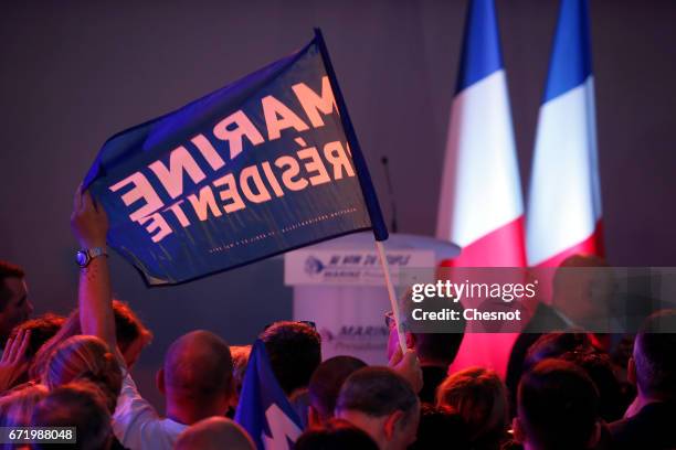 Supporters of National Front leader Marine Le Pen cheer in celebration in the Espace Francios Mitterrand on April 23, 2017 in Henin Beaumont, France....