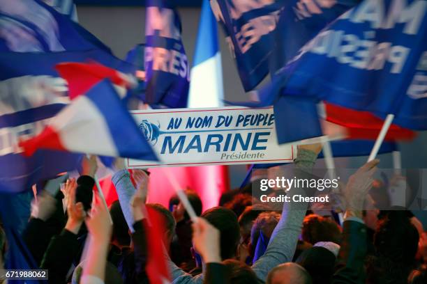 Supporters of National Front leader Marine Le Pen cheer in celebration in the Espace Francios Mitterrand on April 23, 2017 in Henin Beaumont, France....