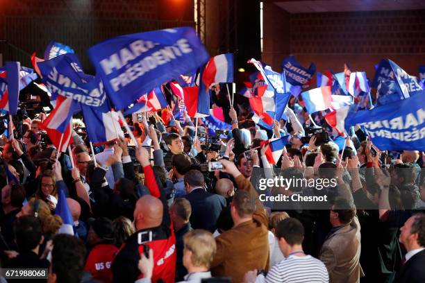 Supporters of National Front leader Marine Le Pen cheer in celebration in the Espace Francios Mitterrand on April 23, 2017 in Henin Beaumont, France....