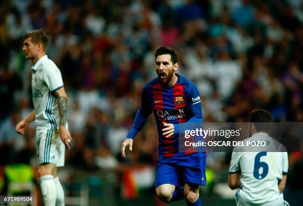 Barcelona's Argentinian forward Lionel Messi celebrates after scoring during the Spanish league Clasico football match Real Madrid CF vs FC Barcelona...