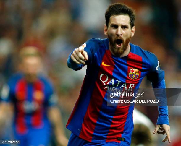 Barcelona's Argentinian forward Lionel Messi celebrates Barcelona's third goal during the Spanish league football match Real Madrid CF vs FC...