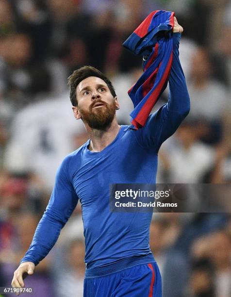 Lionel Messi of Barcelona celebrates as he scores their third goal during the La Liga match between Real Madrid CF and FC Barcelona at Estadio...