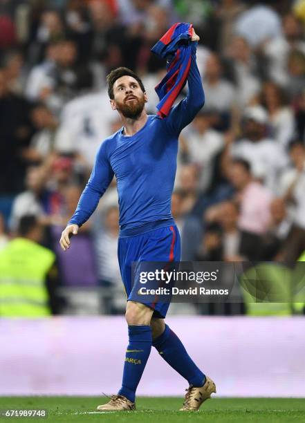 Lionel Messi of Barcelona celebrates as he scores their third goal during the La Liga match between Real Madrid CF and FC Barcelona at Estadio...