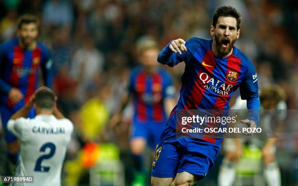 Barcelona's Argentinian forward Lionel Messi celebrates Barcelona's third goal during the Spanish league football match Real Madrid CF vs FC...