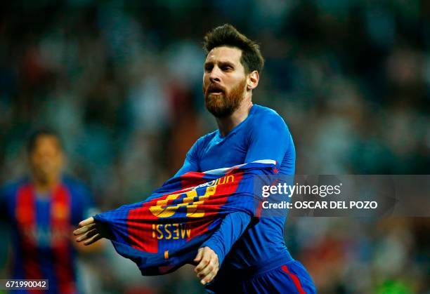 Barcelona's Argentinian forward Lionel Messi celebrates after scoring during the Spanish league Clasico football match Real Madrid CF vs FC Barcelona...