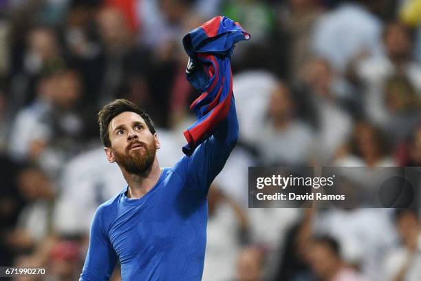 Lionel Messi of Barcelona celebrates as he scores their third goal during the La Liga match between Real Madrid CF and FC Barcelona at Estadio...