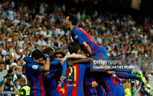 Barcelona's players celebrate after Barcelona's Argentinian forward Lionel Messi scored during the Spanish league Clasico football match Real Madrid...