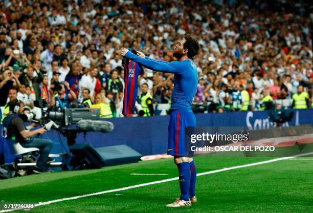 Barcelona's Argentinian forward Lionel Messi celebrates after scoring during the Spanish league Clasico football match Real Madrid CF vs FC Barcelona...