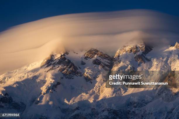 nanga parbat mountain peak covered by cloud in a morning sunrise, chilas, gilgit baltistan, pakistan - nanga parbat stock pictures, royalty-free photos & images