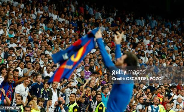 Barcelona's Argentinian forward Lionel Messi celebrates after scoring during the Spanish league Clasico football match Real Madrid CF vs FC Barcelona...