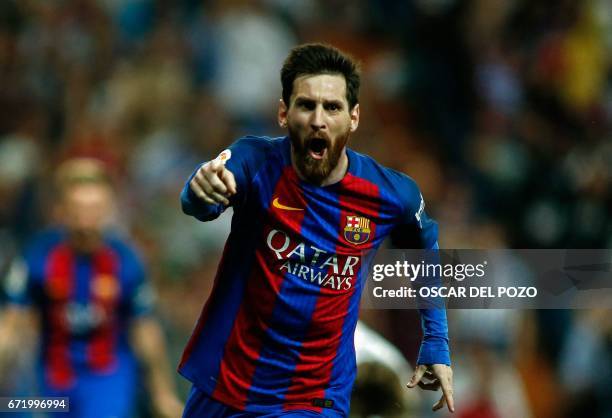 Barcelona's Argentinian forward Lionel Messi celebrates after scoring during the Spanish league Clasico football match Real Madrid CF vs FC Barcelona...