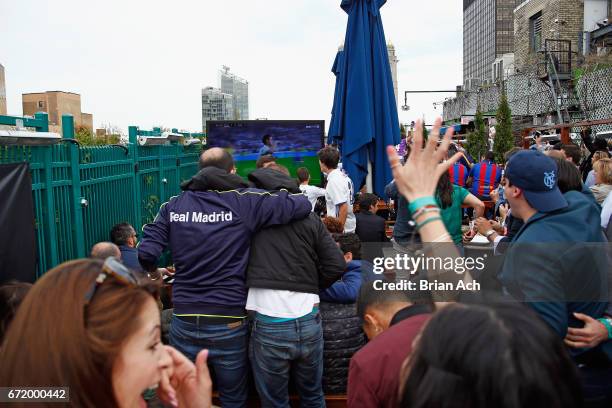 Fans react during a roofop viewing party of El Clasico - Real Madrid CF vs FC Barcelona hosted by LaLiga at 230 Fifth Avenue on April 23, 2017 in New...