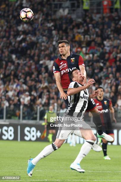 Genoa defender Ezequiel Munoz and Juventus forward Mario Mandzukic head the ball during the Serie A football match n.33 JUVENTUS - GENOA on at the...