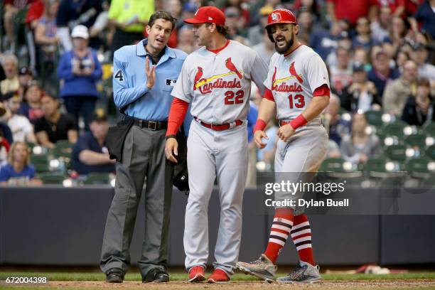 Manager Mike Matheny and Matt Carpenter of the St. Louis Cardinals confront umpire John Tumpane after Carpenter was ejected in the seventh inning...