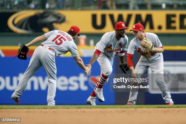 Randal Grichuk, Dexter Fowler, and Stephen Piscotty of the St. Louis Cardinals celebrate after beating the Milwaukee Brewers 6-4 at Miller Park on...