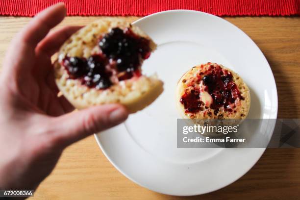 point of view - person eating crumpet - crumpet fotografías e imágenes de stock