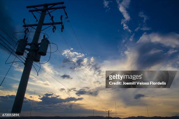 power lines at sunset in cebu city, philippines - joemill flordelis stock pictures, royalty-free photos & images