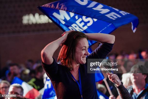 An attendee reacts as results for the first round of the French presidential election are projected at a National Front party in Henin Beaumont,...