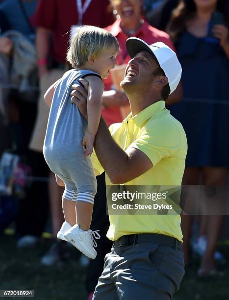Kevin Chappell celebrates with his son Wyatt after putting in to win on the 18th green during the final round of the Valero Texas Open at TPC San...
