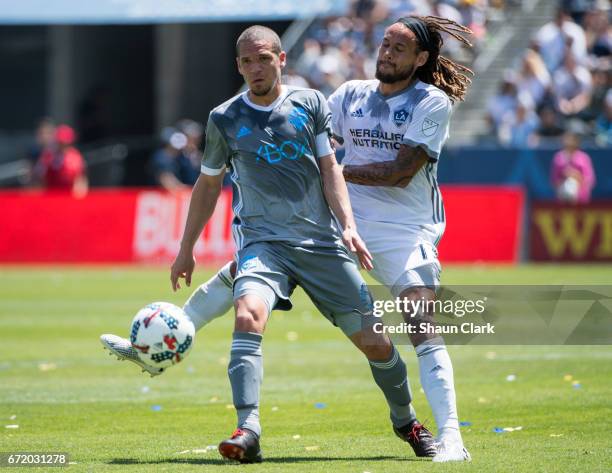 Osvaldo Alonso of Seattle Sounders is defended by Jermaine Jones of Los Angeles Galaxy during Los Angeles Galaxy's MLS match against Seattle Sounders...