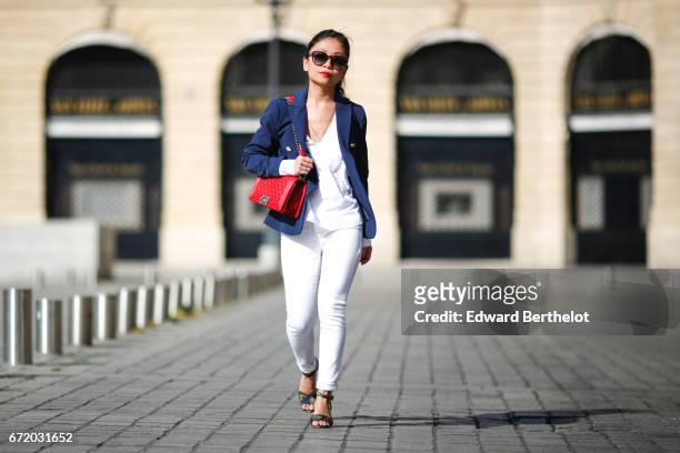 May Berthelot, Head of Legal at Videdressing.com and fashion blogger, wears Saint Laurent YSL sunglasses, a Chanel Boy red bag, a Zara white blouse,...