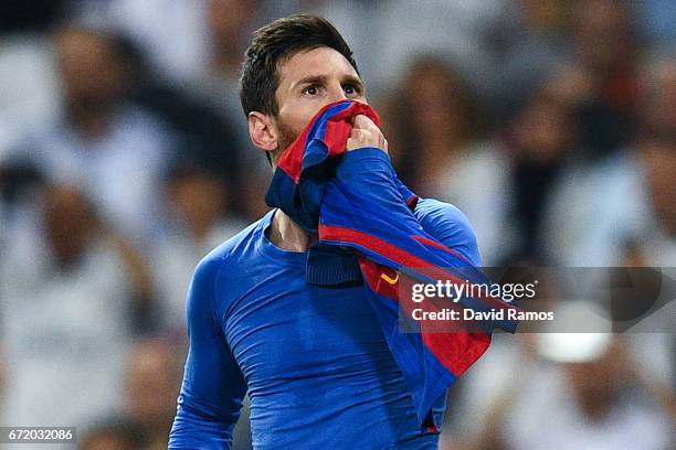 Lionel Messi of FC Barcelona celebrates after scoring his team's third goal during the La Liga match between Real Madrid CF and FC Barcelona at the...