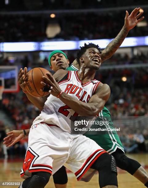 Jimmy Butler of the Chicago Bulls is fouled by Isaiah Thomas of the Boston Celtics during Game Four of the Eastern Conference Quarterfinals during...