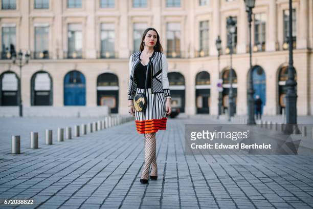 Maria Rosaria Rizzo, fashion blogger La Coquette Italienne, wears a Knitss striped black white and orange skirt, a Knitss black top, a Knitss black...
