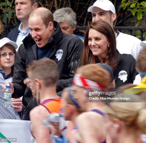 Prince William, Duke of Cambridge is squirted with water as he & Catherine, Duchess of Cambridge hand out water to runners taking part in the 2017...