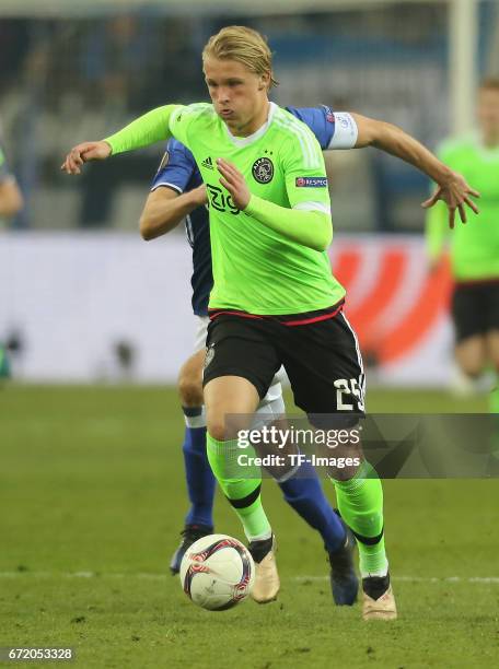 Kasper Dolberg of Ajax and Benedikt Hoewedes of Schalke controls the ball during the UEFA Europa League quarter final second leg match between FC...