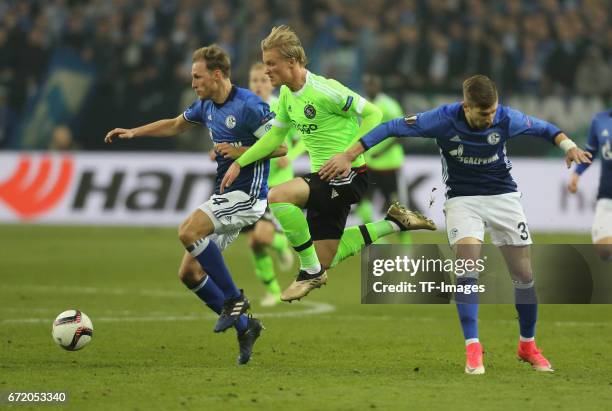 Kasper Dolberg of Ajax Amsterdam and Benedikt Hoewedes of Schalke battle for the ball during the UEFA Europa League quarter final second leg match...