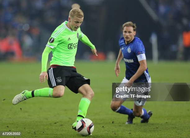 Donny van de Beek of Ajax Amsterdam and Benedikt Hoewedes of Schalke battle for the ball during the UEFA Europa League quarter final second leg match...