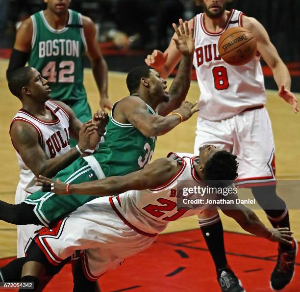 Marcus Smart of the Boston Celtics is called for a charge against Jimmy Butler of the Chicago Bulls as he tries to move between Butler and Isaiah...