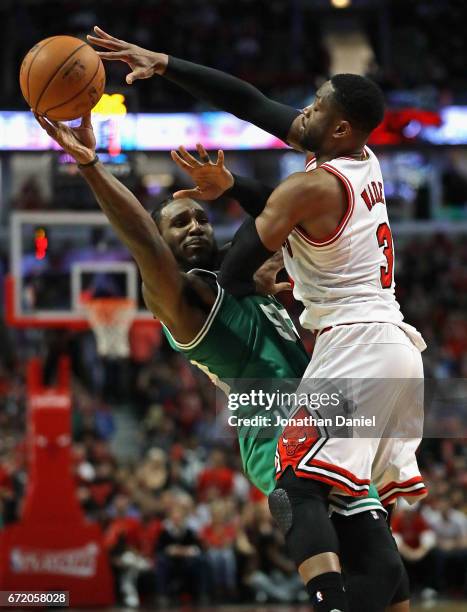 Jae Crowder of the Boston Celtics passes under pressure from Dwyane Wade of the Chicago Bulls during Game Four of the Eastern Conference...