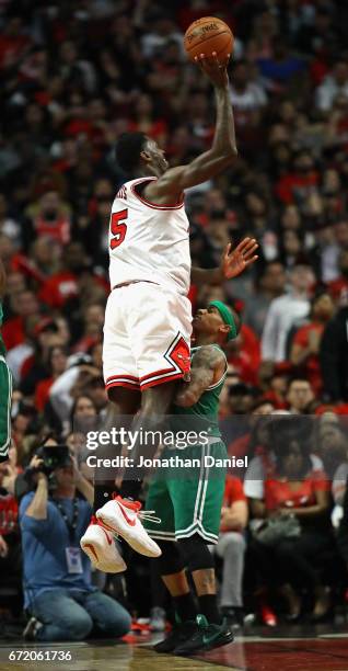 Isaiah Thomas of the Boston Celtics stands his ground as Bobby Portis of the Chicago Bulls is called for a charge while shooting during Game Four of...