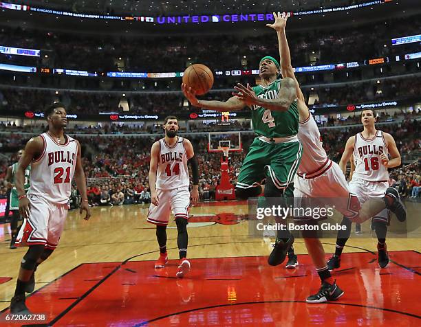 Boston Celtics' Isaiah Thomas scores a layup, splitting the Chicago Bulls defense during the second half. The Boston Celtics visit the Chicago Bulls...