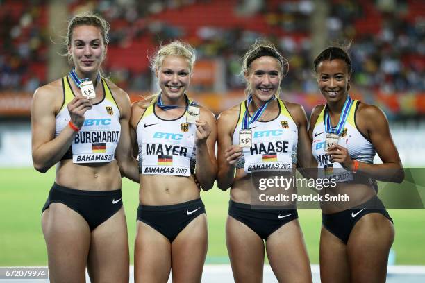 Alexandra Burghardt, Lisa Mayer, Rebekka Haase and Tatjana Pinto of Germany celebrate on the podium after placing first in the Women's 4x100 Metres...