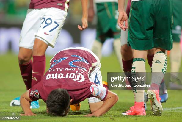 Oribe Peralta of America kisses the grass to celebrate after scoring the first goal of his team during the match between Santos Laguna and America as...