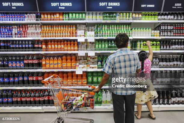 Customers browse soft drinks at a Big Bazaar hypermarket, operated by Future Retail Ltd., in Mumbai, India, on Sunday, April 16, 2017. Future Retail,...