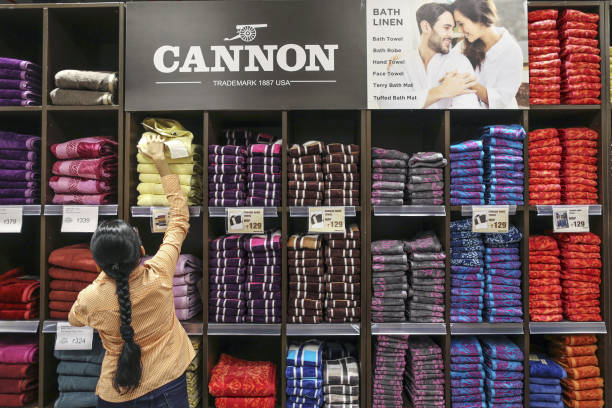 An employee arranges Cannon towels on display at a Big Bazaar hypermarket, operated by Future Retail Ltd., in Mumbai, India, on Sunday, April 16,...