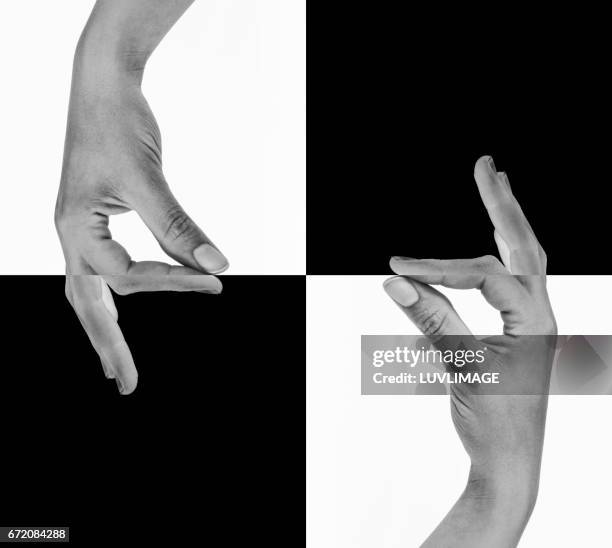 two hands seemingly holding the lines between black and white. - plano descripción física fotografías e imágenes de stock