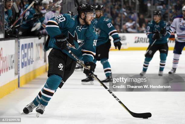 Chris Tierney of the San Jose Sharks skate with the puck against the Edmonton Oilers during the second period in Game Four of the Western Conference...