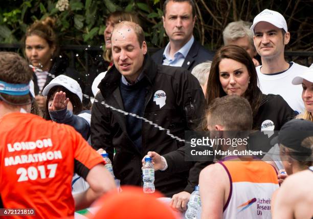 Catherine, Duchess of Cambridge with Prince William, Duke of Cambridge as he gets squirted with water at a water station during the 2017 Virgin Money...