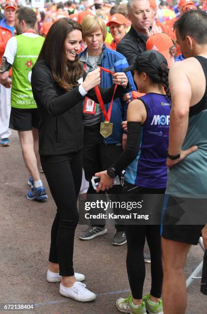 Catherine, Duchess of Cambridge gives out medals to the finishers of the 2017 Virgin Money London Marathon on April 23, 2017 in London, England.