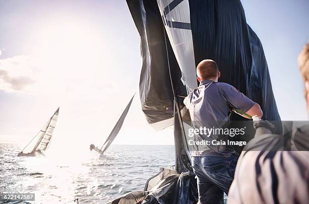 man sailing on sunny ocean - yacht club stock pictures, royalty-free photos & images