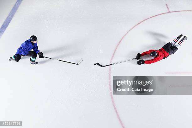 overhead view hockey players diving for puck on ice - ice rink overhead stock pictures, royalty-free photos & images