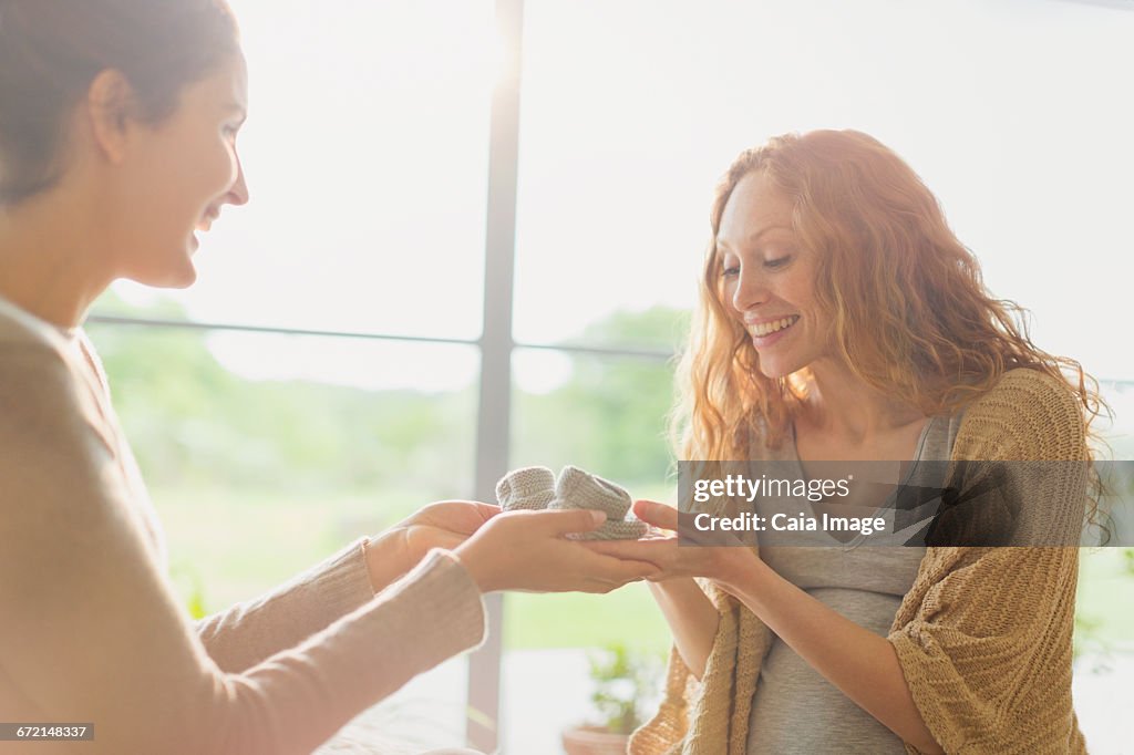 Pregnant women looking at baby booties