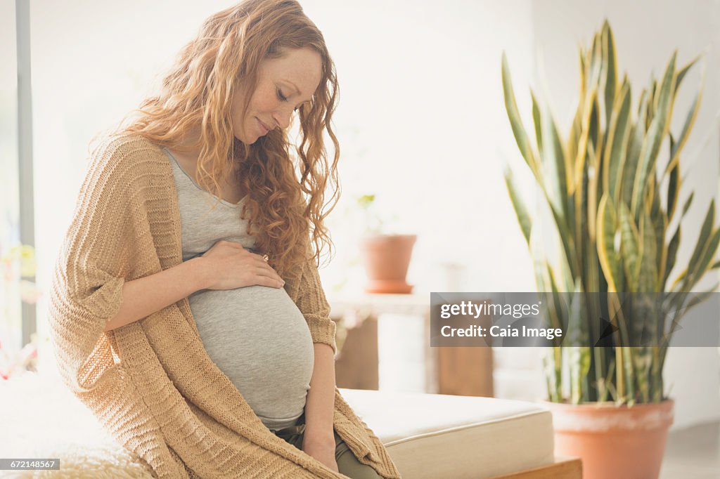 Pregnant woman holding stomach